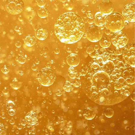 Close-up of oil and water bubbles on a yellow background